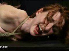 A curly red headed beauty gets a fist in her cunt