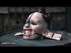 Pain slut gets her hair cut while locked in a barrel