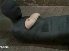 A blonde cutie mummified and hanged upside down