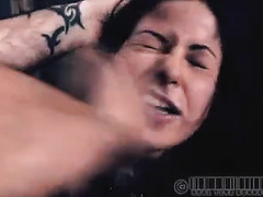 A woman in chains can't see as a shock stick comes near her body