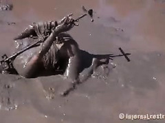 A big-boobed blonde is literally dragged through the mud and fucked