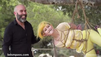 Babe is humiliated in public while being bounded and suspended from a tree