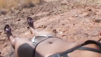 Submissive African girl gets spanked while lying on floor