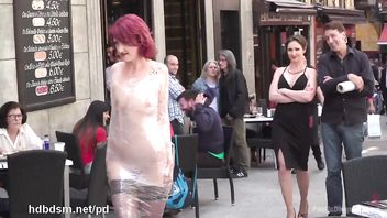 Redhead slave is paraded in public with her naked body wrapped with clingfilm