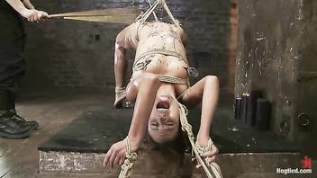 Gorgeous Amber Rayne screams as she's waxed, caned and strung up high