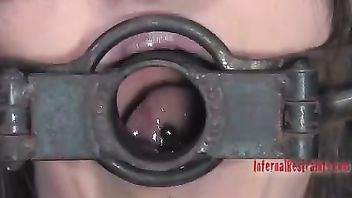 A restrained beauty sucks her Dom's cock before taking it deep in her cunt