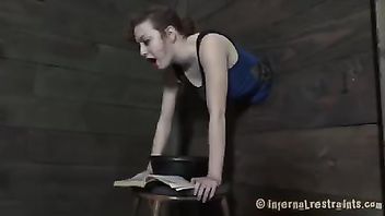 A redhead in the stocks is spanked, caned and fucked by her Master