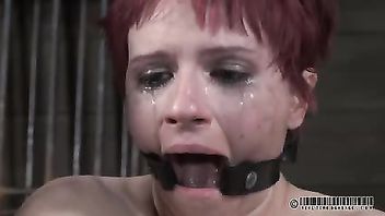 Crying redhead beauty endures master's painful and lusty caning disciplining